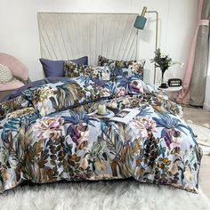 the bed is covered with an elaborately designed comforter and matching pillows, along with a fur rug