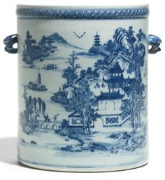 a blue and white porcelain container with landscape designs on it's sides, holding handles