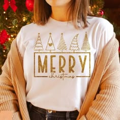 a woman standing in front of a christmas tree wearing a t - shirt that says merry