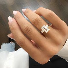 a woman's hand with a diamond ring on it