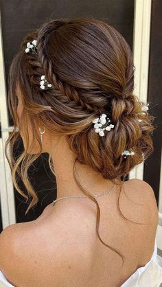 a woman with long hair and white flowers in her hair is looking out the window