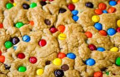 a cookie with m & m cookies on it and multicolored candies in the middle