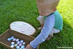 a toddler playing with an easter egg hunt