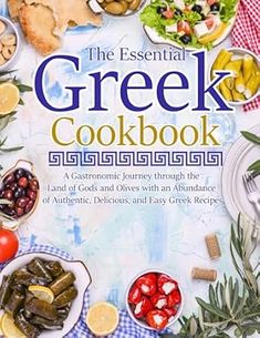 the essential greek cookbook is shown on a table with plates and bowls full of food