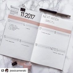 an open planner on top of a marble table