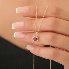 Indulge in the luxurious charm of our Round Ruby Necklace, beautifully handcrafted from 14K solid gold and surrounded by an exquisite ring of real diamonds. This stunning piece features a vibrant, deep red ruby - the birthstone for July - known for its striking color that symbolizes passion and vitality. The captivating contrast of the ruby and shimmering diamonds creates a timeless design that is perfect for special occasions or everyday elegance.  Each necklace is meticulously made by skilled artisans, ensuring that every detail is flawlessly executed. The combination of solid gold and sparkling diamonds not only elevates the overall aesthetic but also guarantees durability and timelessness, so you can cherish this piece for years to come. The secure clasp ensures a comfortable fit, allo Elegant Christmas Diamond Jewelry, Elegant Formal Necklace For Christmas, Elegant Birthstone Necklace With 17 Jewels As Gift, Elegant Gold Plated Birthstone Necklace Gift, Elegant Yellow Gold Christmas Necklaces, Elegant Yellow Gold Christmas Necklace, Christmas Yellow Gold Elegant Necklace, 14k Gold Birthstone Jewelry For Celebration, Elegant Christmas Celebration Jewelry