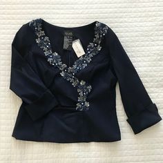 New With Tags, Comes With Spare Beads, Beautiful Navy Blouse With Silver And Navy Embroidery, V-Neck, Fitted, Zipper Down Back, 3/4 Length Cuffed Sleeves, 49% Polyester, 44% Nylon, 7% Lycra, Style #Xs1154, Lining 100% Polyester. Works Extremely Well With This Other Xscape Listing Also In My Closet. Note Sizes. Message Me About Bundling! Https://Bit.Ly/2yqgdny Measurements Are Flat. Pit To Pit 20” Sleeve Length (From Seam) 18” Waist 17.25” Total Length 22.25” Zipper Length In Back 17.5” Blue Button-up Blouse For Formal Occasions, Semi-stitched Embellished Blue Blouse Piece, Blue Embroidered Top With 3/4 Sleeves, Navy Moisture-wicking Collared Top, Navy Embroidery, Blue 3/4 Sleeve Blouse With Button Closure, Navy Blouse, Cuff Sleeves, Blue And Silver