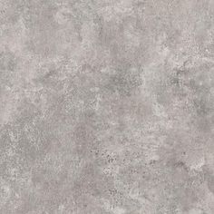 a gray concrete wall textured with light grey paint and some brown spots on it