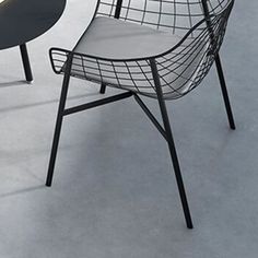 two chairs sitting next to each other on a white floor