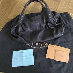 100% Authentic Tods Women’s Handbag / Shoulder Bag With Dust Bag Genuine Leather Black Color Roomy With Inside Zipper And Pockets Smoke And Pet Free Home No Trade Ships Next Day 5 Star Seller New Never Used Style Xbwagqe0300ones804 Size Base About 19inches Height From Handle To Base About 15inches Width Inside The Bag About 12inches Designer Shoulder Bag With Rolled Handles For Errands, Designer Rectangular Bag With Rolled Handles, Designer Double Handle Bag With Rolled Handles, Designer Shoulder Bag With Rolled Handles For Daily Use, Designer Satchel With Rolled Handles For Daily Use, Designer Shoulder Bag With Double Rolled Handles, Designer Shoulder Bag With Double Handles, Designer Satchel Tote With Rolled Handles, Designer Shoulder Bag With Rolled Handles