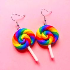 two lollipops are sitting on top of each other in front of a pink background