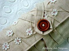 a close up of a piece of cloth with flowers on it and a button in the middle