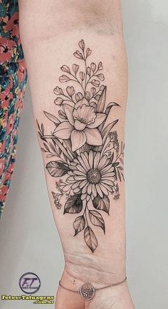 a woman's arm with a flower tattoo on it