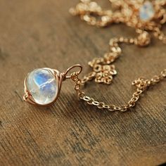 This delicate necklace features a gorgeously glowing rainbow moonstone gem wrapped in 14k rose gold fill and suspended from 14k rose gold fill chain. The natural beauty of this finely faceted stone is striking. Also available in 14k gold fill or sterling silver. Total length- 18 inches (47.5 cm) Moonstone- 9 mm See more~ Coordinating earrings- https://www.etsy.com/listing/538241519/ Gold earrings- http://www.etsy.com/shop/aubepine?section_id=6307607 The rest of my jewelry shop- http://aubepine.e Dainty Rose Gold Moonstone Jewelry, Rose Gold Moonstone Jewelry With Gemstone, Rose Gold Moonstone Gemstone Jewelry, Wire Wrapped 14k Rose Gold Jewelry, Rose Gold Wire Wrapped 14k Gold Filled Jewelry, 14k Gold Filled Rose Gold Wire Wrapped Jewelry, Rose Gold Wire Wrapped 14k Gold Jewelry, Rose Gold Wire Wrapped Necklace, 14k Rose Gold Wire Wrapped Jewelry