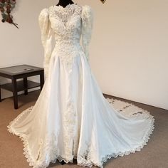 a white wedding dress on display in a room