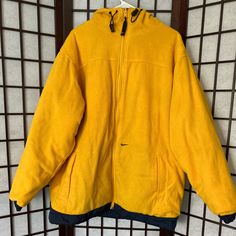 Yellow Fleece/Nylon Nike Reversible Coat With Drawstrings, Slightly Worn But Still A Great Addition To Your Closet! Yellow Fleece Winter Outerwear, Yellow Fleece Long Sleeve Outerwear, Functional Yellow Nylon Outerwear, Sporty Yellow Nylon Windbreaker, Yellow Waterproof Nylon Windbreaker, Reversible Coat, Nike Jacket, Blue Yellow, Nike Men