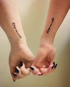 two people holding hands with tattoos on their arms that say, together forever and always