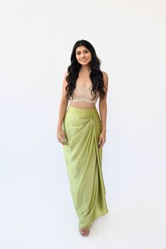 Experience the understated elegance of our Satin Drape Skirt. Crafted with a fitted waistband for a seamless silhouette fit and finished with a timeless drape, this piece is crafted from a luxuriously soft silk satin fabric, perfect for a flowy, feminine look. Features: Zipper and hook closure Fitted waistband High-waisted fit Standard length is typically comfortable for anyone 5'2" to 5'6" Included in purchase: Pista Drape Skirt If you select "custom" as your size option, our team will contact Side Drape Skirt, Satin Dhoti Skirt, Satin Skirt Design, Saree Skirt Drape, Satin Draped Skirt, Dhoti Style Skirt, Satin Clothes Outfit, Draping Skirt Design, Satin Indian Outfit