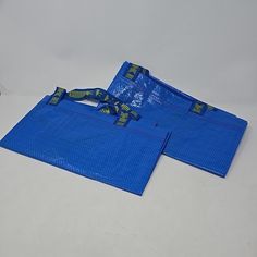 two blue bags sitting on top of each other