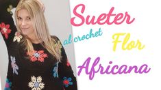 a woman wearing a black sweater with colorful flowers on it and the words, sueter alcret for africa