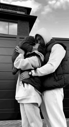 black and white photograph of two people hugging each other