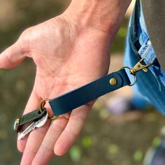 a person holding two keys in one hand and a pair of scissors in the other