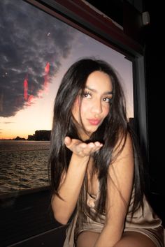 a beautiful young woman sitting on top of a boat