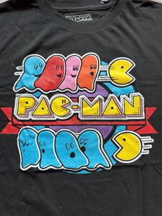 a black shirt with the words pac - man on it