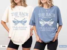 two women standing next to each other wearing shirts with the words, the beach and lake tahoe on them