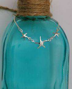 Sterling Silver Starfish Bracelet This pretty little bracelet has 3 little starfish and is a must have for beach and ocean lovers. It is 17.5cms in Length. If you are buying this as a gift for someone and want to make it extra special, how about adding one of our Messages in a Bottle...  We have 6 bottle designs to choose from and a  number of different messages and quotes that can be included on your scroll. Please follow the following link for our Messages in a bottle. https://oceansofsilvershop.etsy.com/uk/listing/1168876950/message-in-a-bottle-keepsake Your Message in a bottle will be delivered with your Jewellery. Free Postage and Delivery in the UK and US. All Items are dispatched in 1-2 days with standard Royal Mail. Our Jewellery  is beautifully packaged & includes an Oceans of Sil Star-shaped Bracelet With Starfish Charm Gift, Starfish Charm Bracelet As Gift, Silver Starfish Bracelet For Gift, Starfish Charm Bracelet As A Gift, Silver Starfish Bracelet, Starfish Charm Bracelet Gift, Ocean-inspired Starfish Bracelets As Gifts, Adjustable Starfish Charm Bracelet Gift, Messages In A Bottle