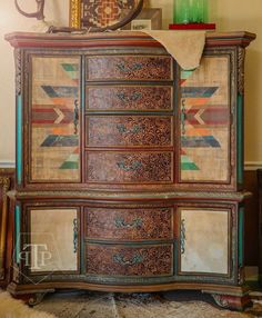 an old dresser has been painted with colorful patterns and designs on it's sides