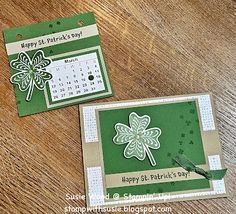 two st patrick's day cards sitting on top of a wooden table