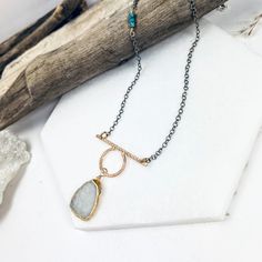 Your favorite gemstone is just on the horizon! This beautiful slab of rainbow moonstone drops from a unique, hand forged pendant which blends textures and shapes. This beauty is accented with textured, oxidized sterling chains and tiny heishi turquoise gemstones. •14k gold filled and sterling silver •Moonstone and turquoise •Pendant Dimensions: 1.25 x 1.5" •Length: 17" Bohemian Hand Forged Jewelry For Everyday Wear, Bohemian Hand Forged Jewelry For Everyday, Bohemian Hand Forged Everyday Jewelry, Everyday Bohemian Hand Forged Jewelry, Forged Pendant, Sterling Chains, Metalwork Jewelry, On The Horizon, Jewelry Repair