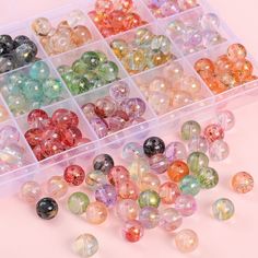 many different colored beads in a plastic container