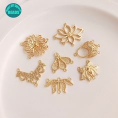 gold plated charms on a white plate