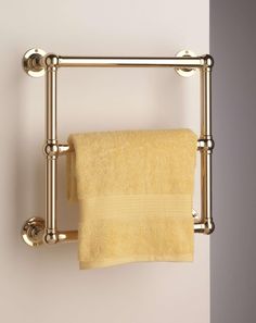 a towel rack with two towels hanging on it's sides and one folded yellow towel in the middle