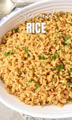 a white bowl filled with rice and garnished with parsley on the side