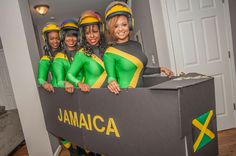 a group of women in green and yellow outfits standing behind a sign that says jamaica