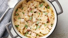 a pot filled with pasta and peas on top of a table