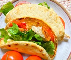 a taco with lettuce and tomatoes on a plate