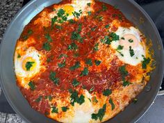 an omelet with eggs and parsley in a pan