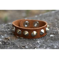 Handcrafted leather bracelet with one row of short metal spikes. You can adjust the length, as it comes with two different buttons. Width 18mm. Length 23cm. Minimum wrist measurement 19cm. We suggest you measure your wrist and give us the measurement before shipping. Trendy Adjustable Spiked Bracelets, Adjustable Silver Bracelet With Spikes, Adjustable Spiked Jewelry For Gift, Adjustable Spiked Jewelry As Gift, Adjustable Cuff Bracelet With Rivets, Trendy Adjustable Bracelets With Rivets, Adjustable Brown Punk Bracelets, Adjustable Leather Wristband With Rivets, Adjustable Vintage Leather Bracelet With Rivets