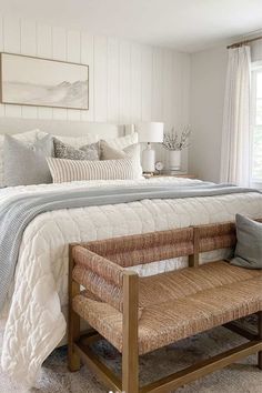 a bedroom with white walls and neutral decor