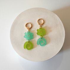 These super fun mismatched earrings are bright and playful. They come in two color-ways. gold or rhodium plated stainless steel huggie hoops acrylic 2 in x .5 in Trendy Green Dangle Hoop Earrings, Modern Green Hoop Earrings As Gift, Trendy Green Hoop Earrings, Playful Green Jewelry With Matching Earrings, Trendy Green Hypoallergenic Earrings, Trendy Hypoallergenic Green Earrings, Funky Green Earrings As A Gift, Funky Green Earrings For Gift, Mint Gold