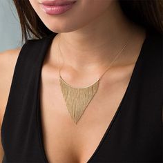 Update your dressy attire with this sensational bib necklace. Created in warm 10K gold, this stylish look features a curved bar adorned with shimmering tapered lengths of diamond-cut bead chain. Buffed to a brilliant luster, this design suspends centered along a 16.0-inch bead chain with 2.0-inch extender that secures with a spring-ring clasp. Yellow Gold Diamond Cut Necklace For Party, Elegant Gold Bib Necklace For Evening, Elegant Gold Bib Necklace As A Gift, Elegant Gold Bib Necklace With Adjustable Chain, Elegant Gold Bib Necklace With Beaded Chain, Elegant Gold Bar Necklace With Adjustable Chain, Adjustable Gold Necklaces With Beaded Fringe, Gold Beaded Metal Bib Necklace, Tapered Fringe