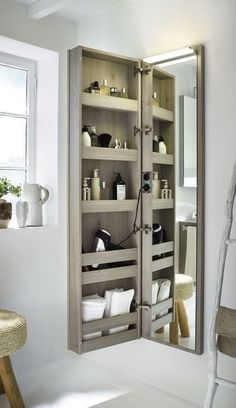 a bathroom with a large mirror and shelves in it