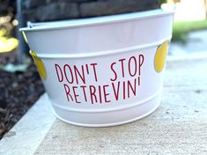 a white bucket that says don't stop retrieving on the side of it