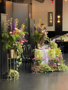 tables and chairs are covered with flower arrangements