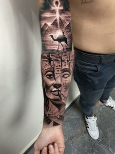 a man's arm with tattoos on it and an image of the egyptian god