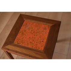 a wooden table with an orange surface on it